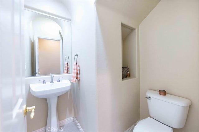 bathroom with vaulted ceiling and toilet