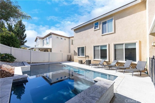 view of pool featuring central air condition unit and an in ground hot tub