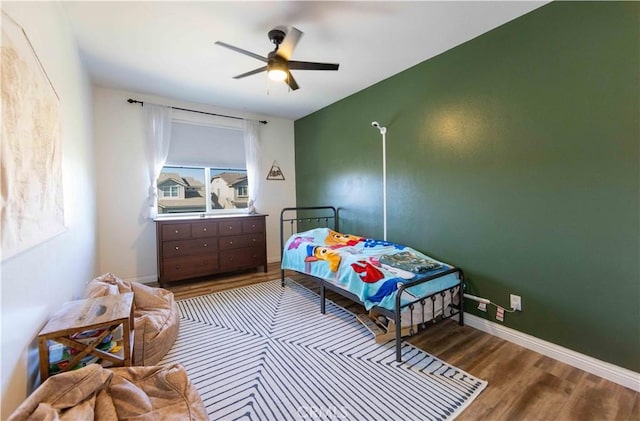 bedroom featuring hardwood / wood-style floors and ceiling fan