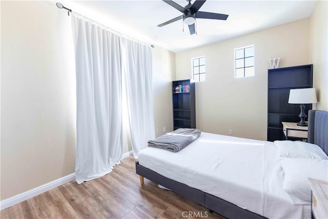 bedroom with ceiling fan and wood-type flooring