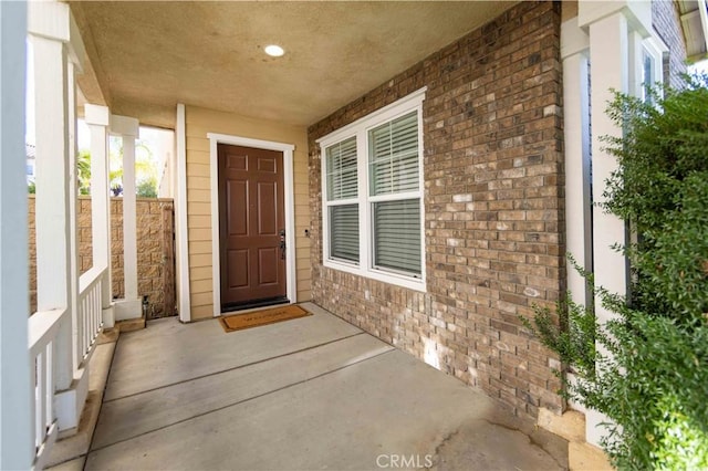 view of exterior entry featuring a porch