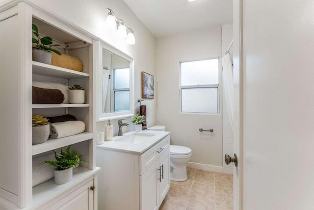 bathroom featuring curtained shower, tile patterned flooring, vanity, and toilet