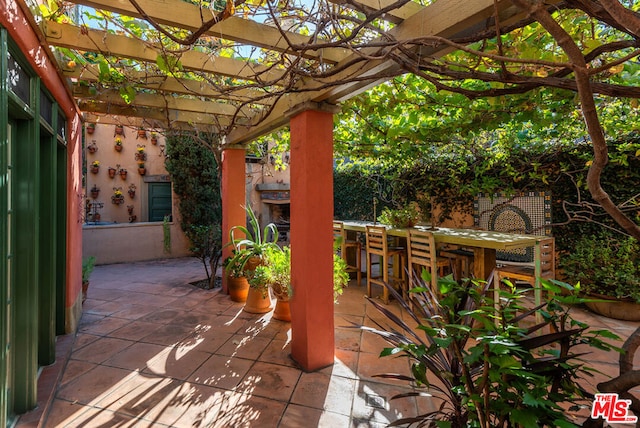 view of patio / terrace with a bar and a pergola