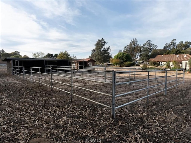 view of horse barn featuring a rural view