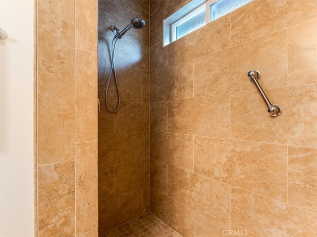 bathroom with a tile shower