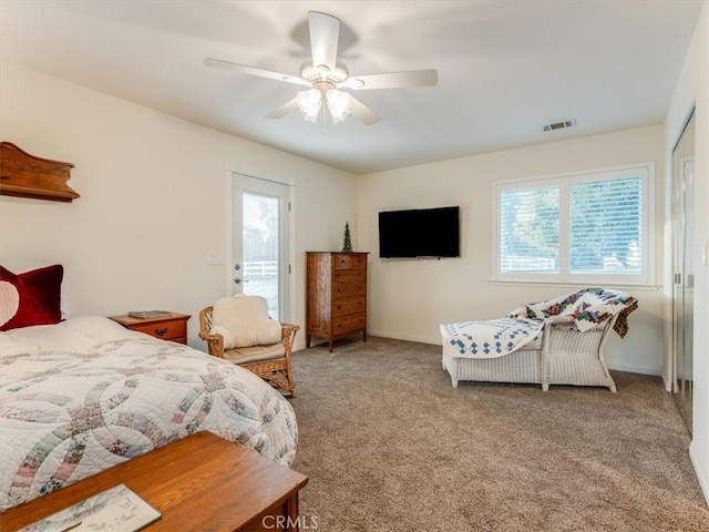 carpeted bedroom featuring ceiling fan, access to outside, and multiple windows