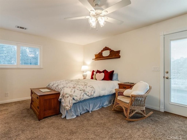 bedroom featuring carpet flooring, ceiling fan, and multiple windows