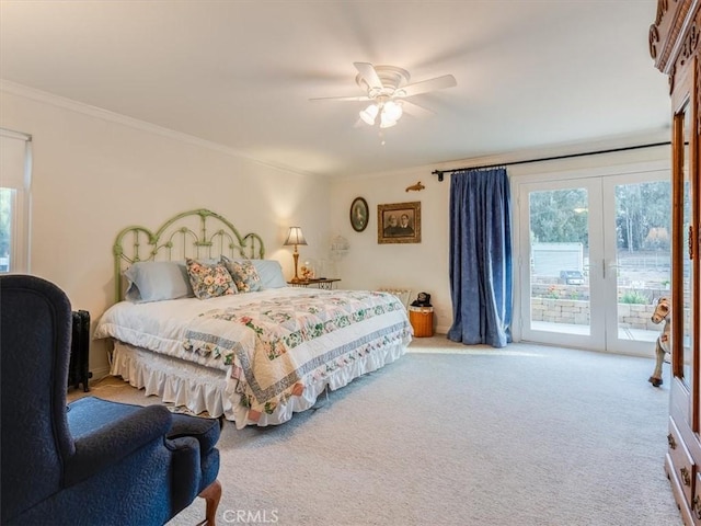 carpeted bedroom featuring access to outside, ceiling fan, crown molding, and french doors