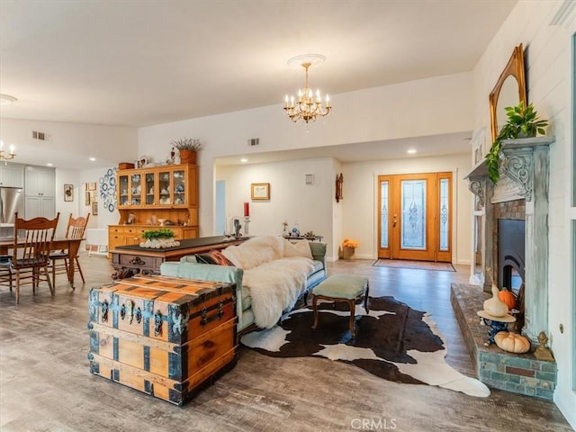 living room with hardwood / wood-style flooring and a notable chandelier