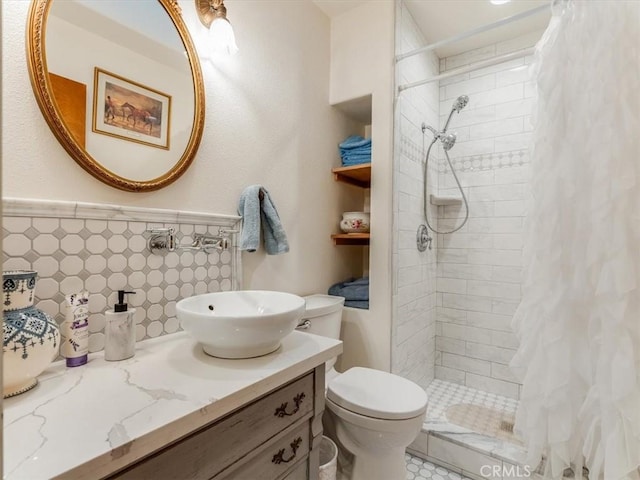 bathroom featuring vanity, toilet, tile walls, and walk in shower