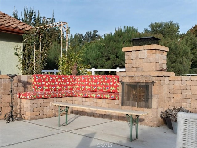 exterior space with an outdoor stone fireplace