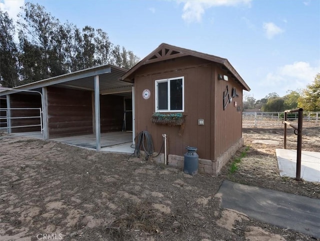 back of house with an outdoor structure