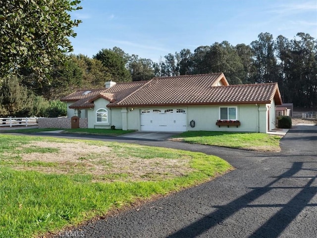 view of front facade with a garage and a front lawn