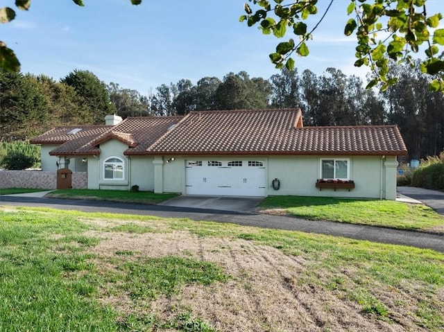 view of front of home with a front yard and a garage