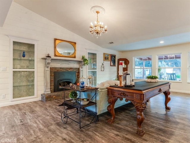 interior space with hardwood / wood-style floors, a chandelier, and vaulted ceiling