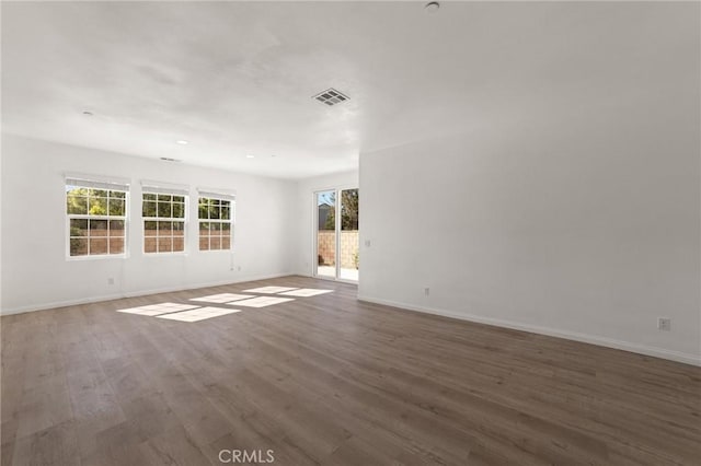 spare room featuring dark wood-type flooring