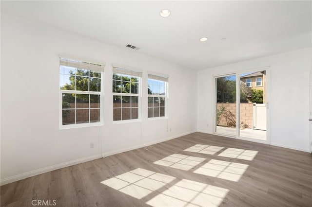 spare room with hardwood / wood-style floors