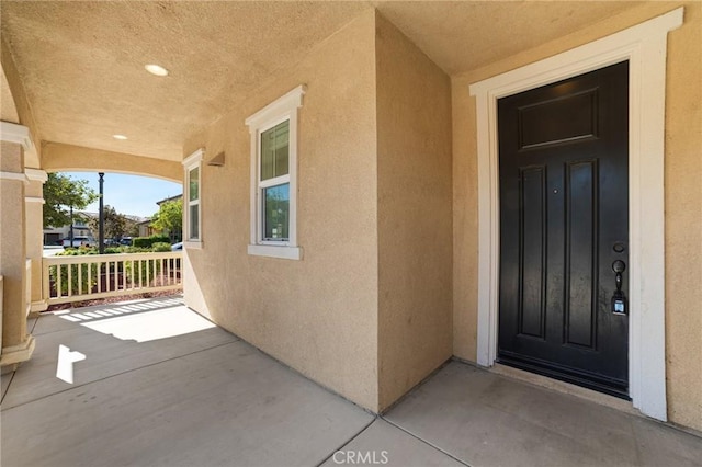 view of exterior entry with covered porch