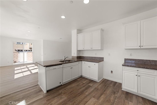 kitchen with kitchen peninsula, white cabinetry, dark hardwood / wood-style flooring, and white dishwasher