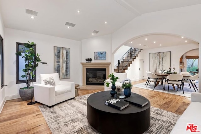 living room featuring vaulted ceiling and light hardwood / wood-style flooring