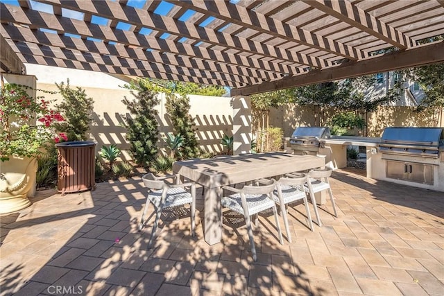 view of patio featuring area for grilling and a pergola