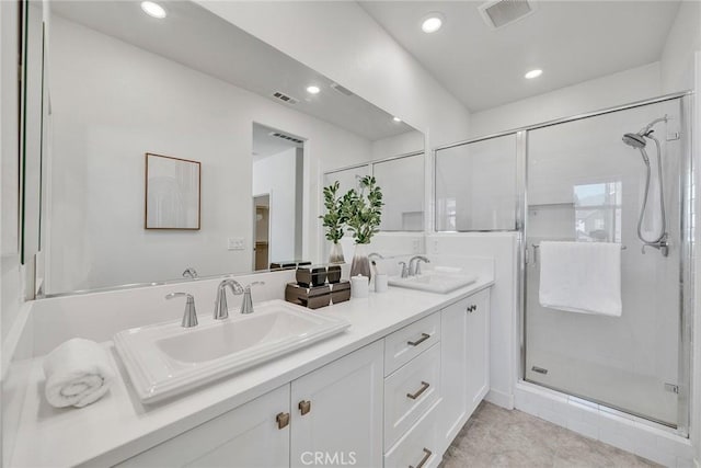 bathroom with tile patterned flooring, vanity, and a shower with shower door