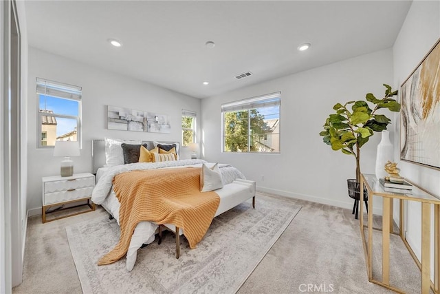 bedroom featuring light carpet