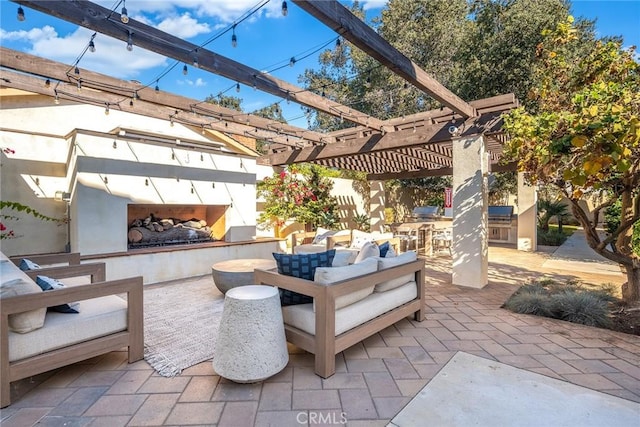 view of patio with a pergola and an outdoor living space with a fireplace