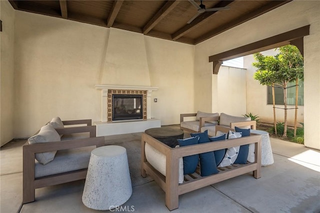 view of patio featuring an outdoor living space with a fireplace and ceiling fan