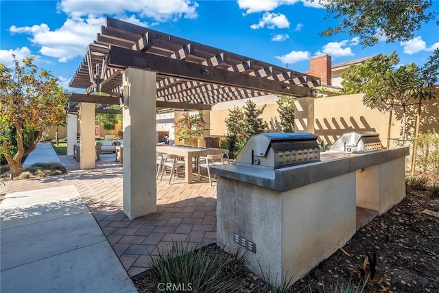 view of patio / terrace featuring an outdoor kitchen, grilling area, and a pergola