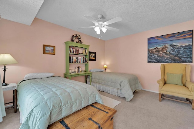 bedroom featuring carpet, a textured ceiling, and ceiling fan