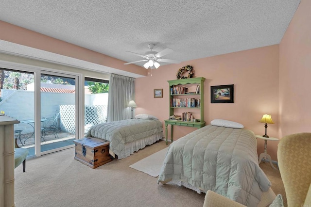 carpeted bedroom with ceiling fan, a textured ceiling, and access to outside