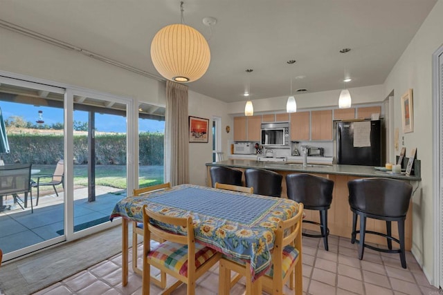 dining space featuring light tile patterned flooring