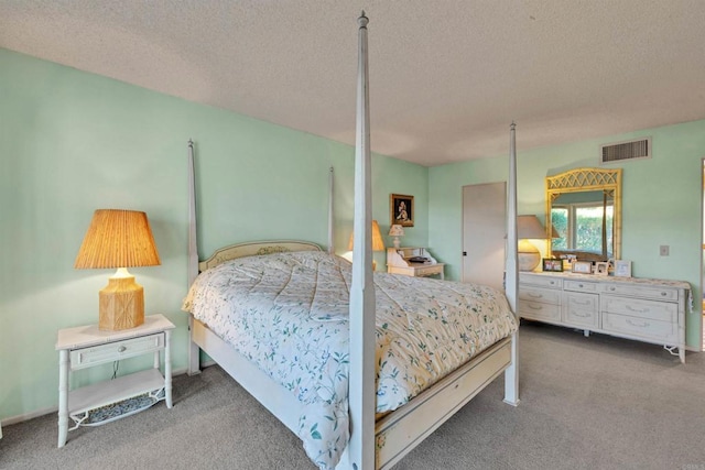 carpeted bedroom featuring a textured ceiling