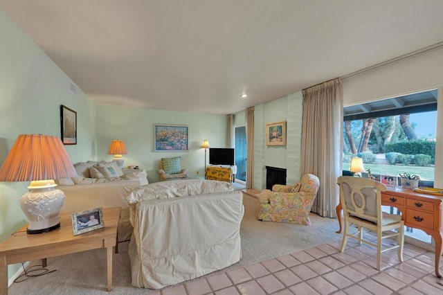 carpeted living room with a large fireplace