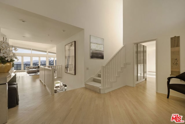 stairway featuring wood-type flooring and lofted ceiling