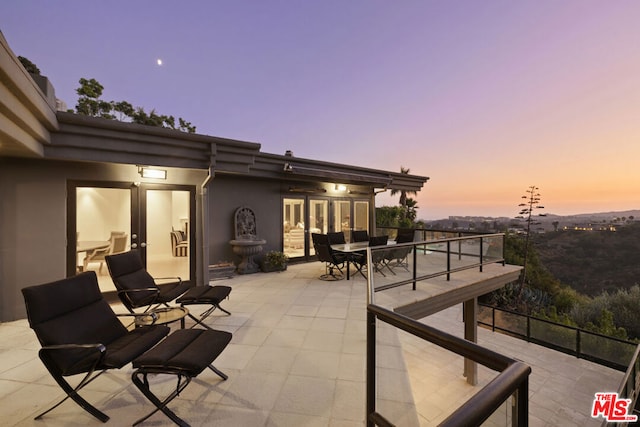 patio terrace at dusk with a balcony