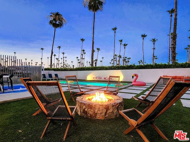 view of community featuring a pool and an outdoor fire pit