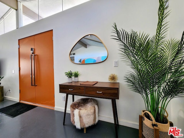 foyer entrance featuring high vaulted ceiling