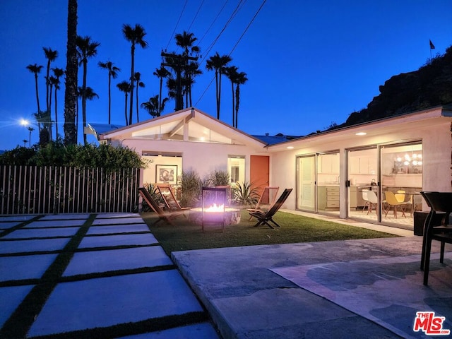 rear view of house featuring a patio area and a yard