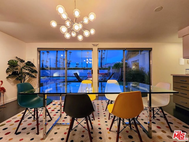 dining space featuring light hardwood / wood-style flooring and a notable chandelier