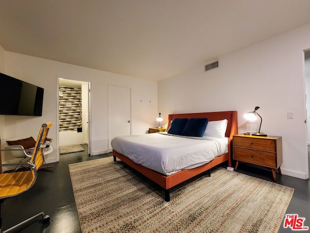 bedroom with concrete floors and a closet