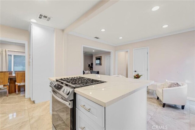 kitchen featuring visible vents, crown molding, recessed lighting, stainless steel gas stove, and white cabinetry