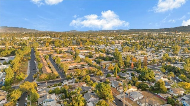 drone / aerial view featuring a residential view and a mountain view