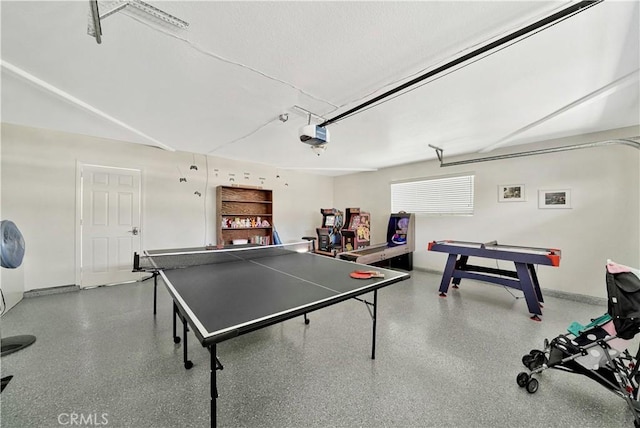 recreation room featuring a textured ceiling