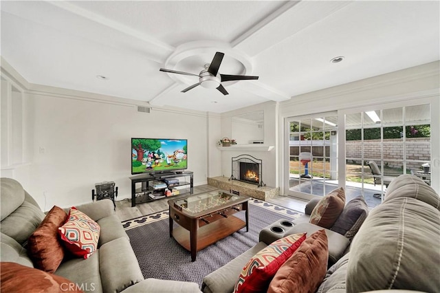 living room featuring hardwood / wood-style floors, ceiling fan, and beam ceiling