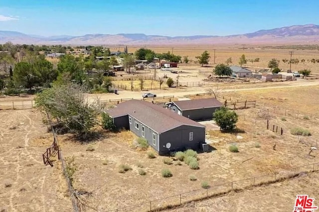 birds eye view of property featuring a mountain view and a rural view