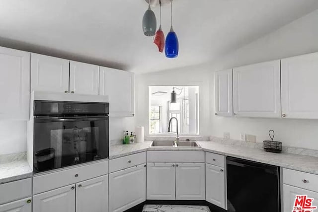 kitchen with vaulted ceiling, sink, black appliances, pendant lighting, and white cabinets