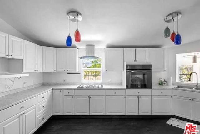 kitchen with black oven, white cabinets, sink, and wall chimney exhaust hood