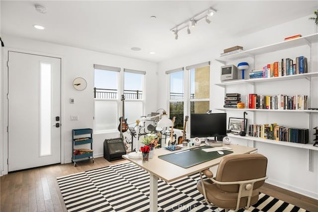 office area featuring hardwood / wood-style floors and track lighting